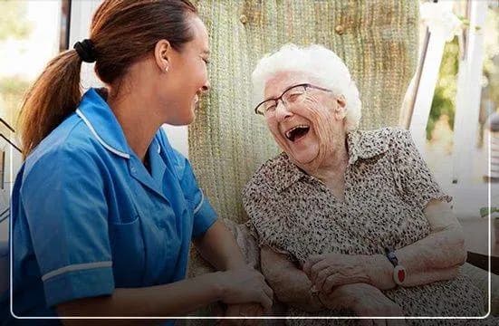 Focus Family Care caregiver laughing with a happy senior client at home in South Florida