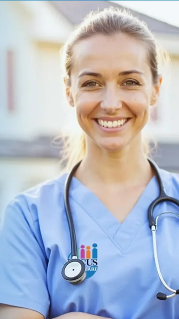 Focus Family Care nurse in scrubs smiling in front of a South Florida home in West Palm Beach